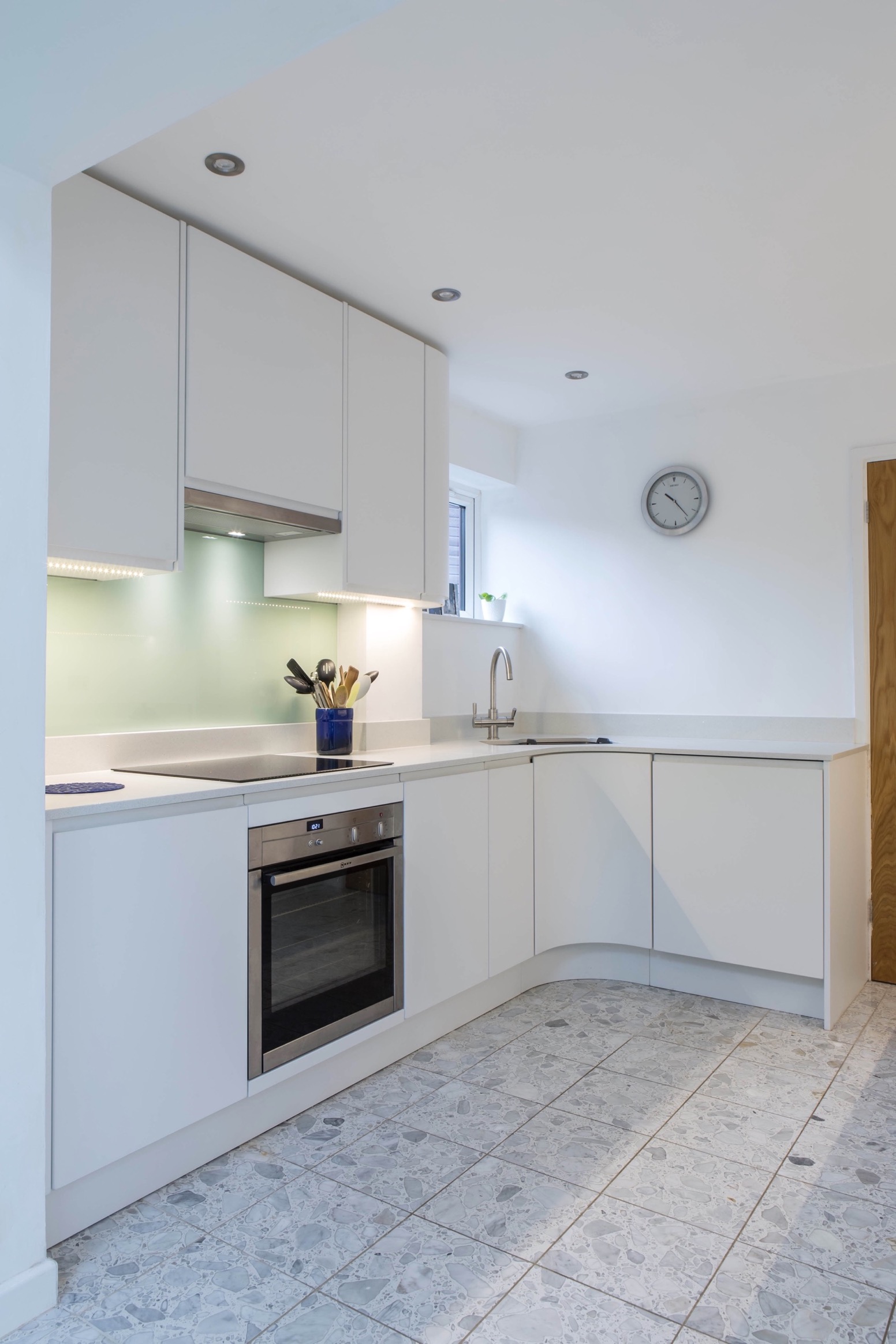 white handleless induction hob under cupboard lights oxford thame bespoke kitchen 2 1